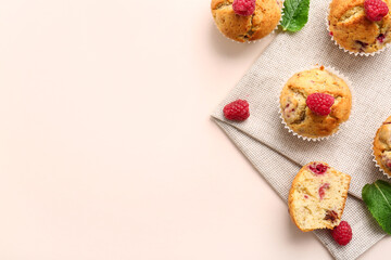 Tasty raspberry muffins on color background