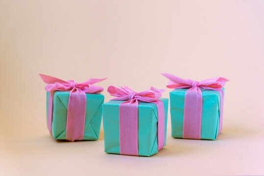 Three teal blue present boxes with bows. Winter holidays concept. Front view