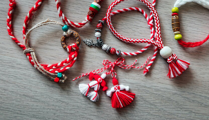 Bulgarian traditional spring decor martenitsa bracelets, wooden background. Baba Marta holiday, backdrop.