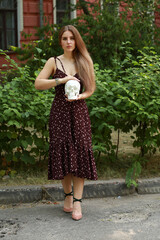 Young woman with a skull in her hands in the park