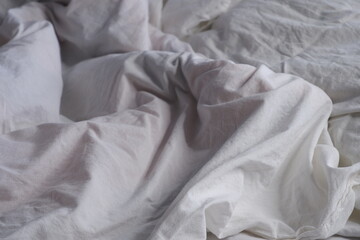 Bed linen texture. White bed linen background. Bed. Interior.