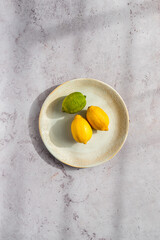 Organic lemons in white ceramic bowl
