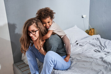 Girl embracing her lovely mother while enjoying of the morning with her