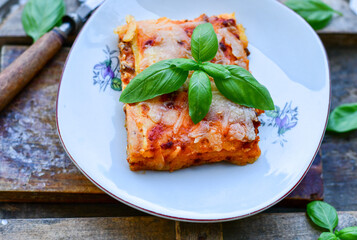   Delicious Home made keto diet  Lasagna bolognese  with  Lupin Flour, minced meat,tomato sauce and spinach  on a wooden rustic  background.Home made low carb italian meal