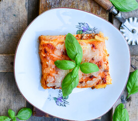   Delicious Home made keto diet  Lasagna bolognese  with  Lupin Flour, minced meat,tomato sauce and spinach  on a wooden rustic  background.Home made low carb italian meal