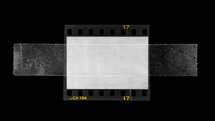 empty or blank 35mm dia film frame fixed by transparent sticker adhesive tape on black background....