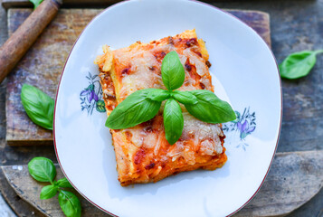   Delicious Home made keto diet  Lasagna bolognese  with  Lupin Flour, minced meat,tomato sauce and spinach  on a wooden rustic  background.Home made low carb italian meal