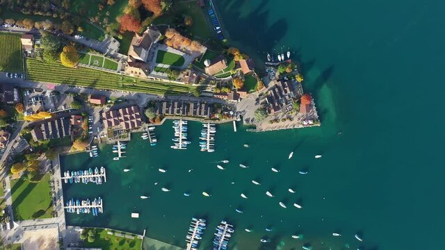 Aerial top drone footage of the Spiez old town and marina by lake Thun in Canton Bern in Switzerland