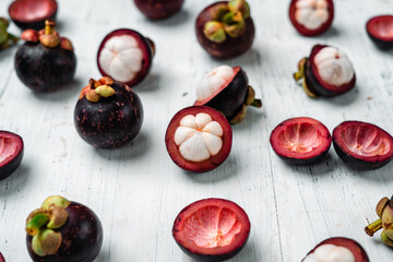 Mangosteen fruit on white wooden background