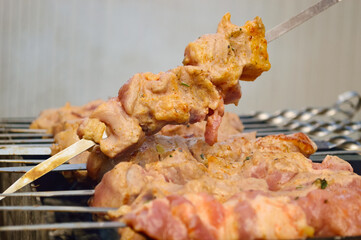 close-up - barbecue is fried on the grill, meat in pieces on skewers