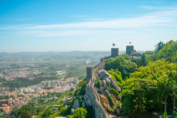 Landscape of an old fortress wall and the city at the bottom of the hill - Moorish Castle, Sintra, Portugal - Space for text, 28.05.2021