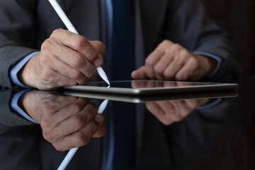 Business man in suit hand using electronic pen (stylus pencil, digitized pen) sign contract on...