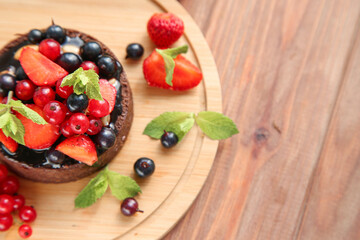 Chocolate tart with berries and mint with place for text. Top view