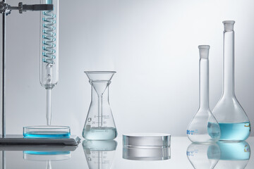 
Assorted laboratory glassware equipment showcase with blue water on white backround. Stage...