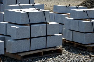 granite curbs of cut granite. smooth stoneware products stacked on a pallet ready for transport to...
