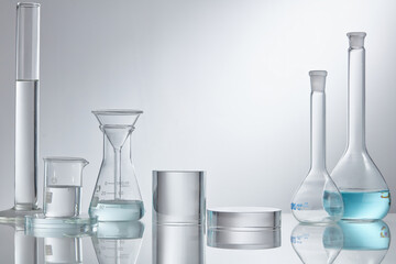 Laboratory glass equipment with blue water ingredients on white background. Research and...