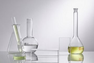 Assorted laboratory glassware equipment showcase with oil on white backround. Stage showcase...