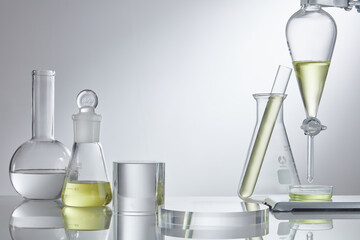Assorted laboratory glassware equipment showcase with oil on white backround. Stage showcase...