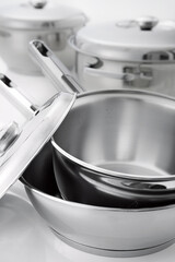 conjunto de panelas inox em fundo branco