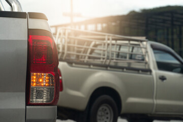 Rear side of pick-up car with turn light signal for U-Turn. Want to make a U-turn in front of the car and other cars.
