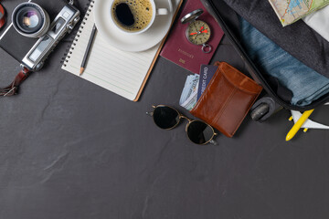 Prepare a suitcase,  vintage camera,  notebook, passport, map and hot coffee