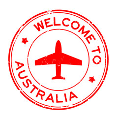 Grunge red welcome to Australia word with airplane icon round rubber seal stamp on white background