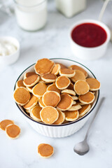 popular mini pancakes with berry jam in bright colors