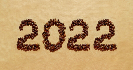 2022 of coffee beans on a brown craft paper background. Happy New 2022 Year