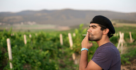 male person smoking the cigar outdoors