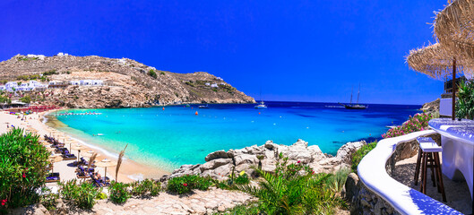 Greece summer holidays. Cyclades .Most famous and beautiful beaches of Mykonos island - Super Paradise beach popular tourist resort - obrazy, fototapety, plakaty