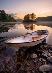Beautiful Derwentwater sunrise with rowing boat, Lake District, UK.