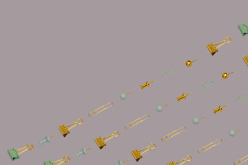 Back to school creative concept. Gold and grey paper clips and pin pattern on a purple background. Business backdrop. Top view, flat lay. Seamless image.