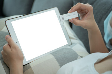 Asian young woman using SARS 2019-nCoV COVID-19 coronavirus antigen rapid test kit.