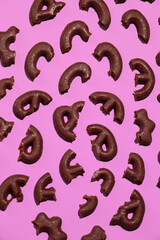 Obraz premium Chocolate cookies half on pink background. Sweets cacao lover concept. Minimal art. Holidays party time, winter christmas celebration season wallpaper