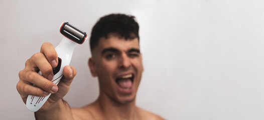 a handsome dark-haired boy showing a razor.