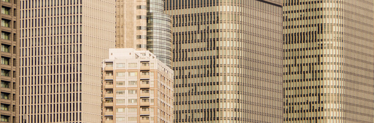 futuristic golden modern crowded office tower and apartment buildings close up view banner