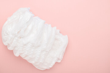 Diapers are disposable panties on a pink background with a place to copy. top view, copy space.