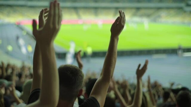 Fans at the stadium during the match. Slow motion