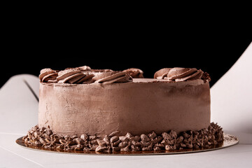 Piece of chocolate truffle cake on black background
