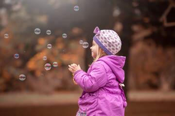 Girl, garden, lilac coat, soap bubble blower