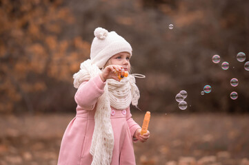 Girl, garden, pink coat, soap bubble blower, fun