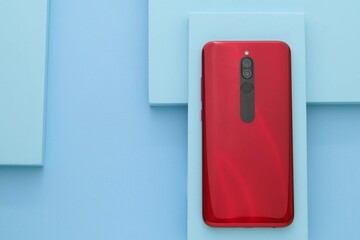 Red smartphone on the blue board, Blue table