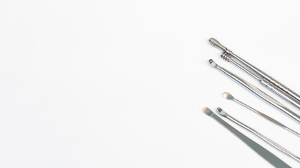 close up steel ear cleaner tools with white background	