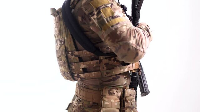 Man in body armor with automatic rifle