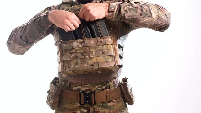 Man fixes loaded rifle magazines