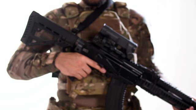 Soldier with rifle enters from defocus