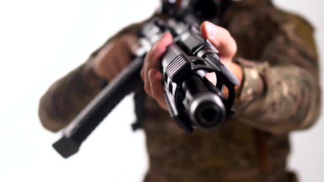 Military mercenary aims an automatic rifle 
