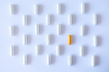 Medication capsule pattern. White capsules and red capsule on a white background.