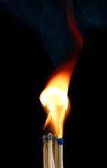 Ignited matchsticks burning bright flame, fire isolated on black background with clipping path