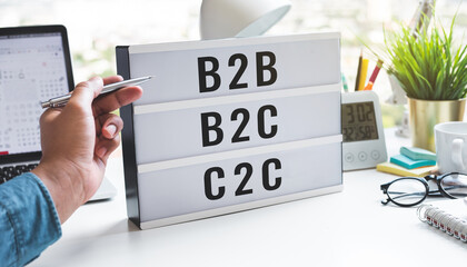 Business goal and marketing with b2b,b2c,c2c text on light box on table.management and service